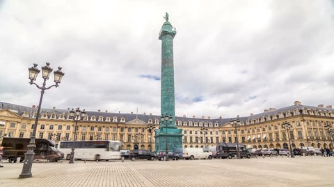 Vendome column with statue of Napoleon Bonaparte on the Place Vendome timelapse hyperlapse. Paris, France. Cloudy sky at summer day and traffic on road