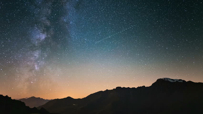 Meteor explosion, meteor shower and stardust smoke trail in night sky, time lapse of the Milky Way and the starry sky over the Alps. | Shutterstock HD Video #31974175