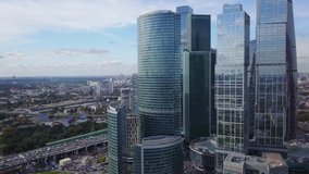 4K aerial high quality aerial video of Moscow City area, International business center, Moscow River with bridge, skyscrapers and boats along the river in Russia on cloudy quiet autumn September day