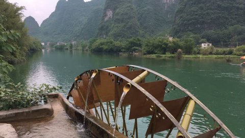 waterwheel beside the river in yangshuo china