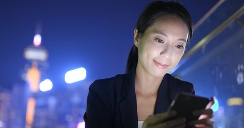 Business woman using smart phone in Hong Kong city