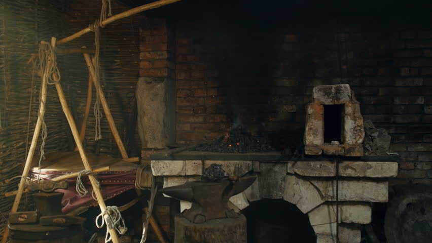 The interior of the smithy. Sparks and flames from the fire being distributed. Solar rays from the window.