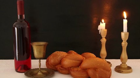 shabbat footage. challah bread, shabbat wine and candles on the table