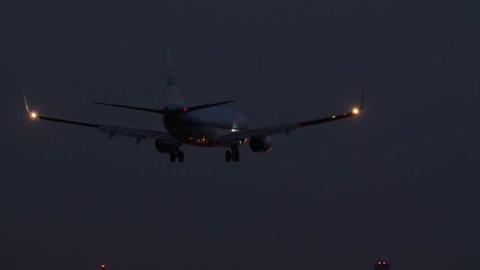 Amsterdam, October 2017. Airplane landing at night.