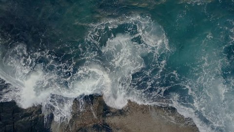 Waves Rushing Rocks, Deep blue and smooth waves. Aerial Top View 4K UHD