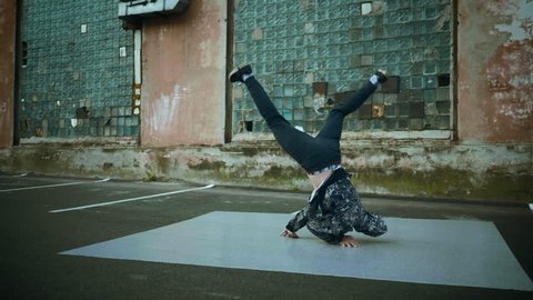 Hip-hop and breakdancing. Breakdancer dancing in the street. Slow motion. HD
