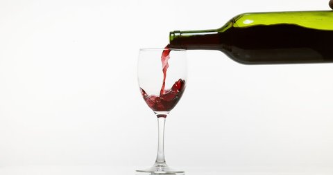 Red Wine being poured into Glass, against White Background, Slow motion 4K