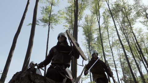Vikings running in the forest to fight in a battle