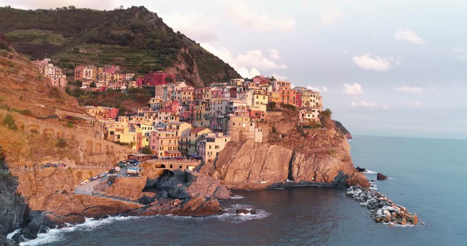 Amazing aerial view of Manarola village on cliff rocks and turquoise sea.Stunning view of beautiful and cozy town in Cinque Terre Reserve,Liguria,Italy,Europe.Travel destination, adventure concept. Royalty-Free Stock Footage #32014990