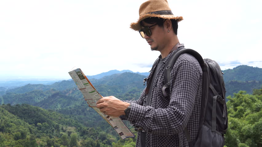 Asian Man tourist  looking on the map ,thailand