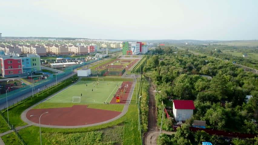 camera is flying over sports areas, children playgrounds and schools zone in new city district Royalty-Free Stock Footage #32022742