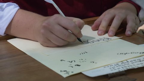 Close up of an amanuensis writing on paper during a middle ages reenacting on July 28 2017, Arezzo (Italy)