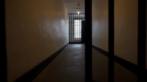 Prison Bars Close in a Dark, Depressing Jail Cell, Solitary Confinement