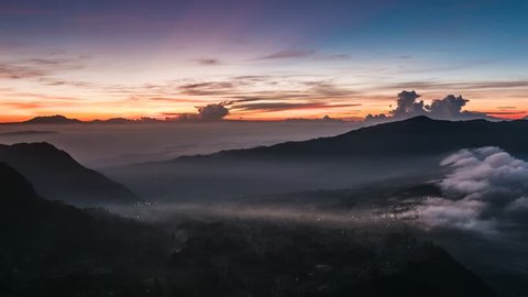 Java, Indonesia.  Morning time lapse nature landscape of Java island. Sunrise clouds and foggy mountains. UHD 4K Adlı Stok Video