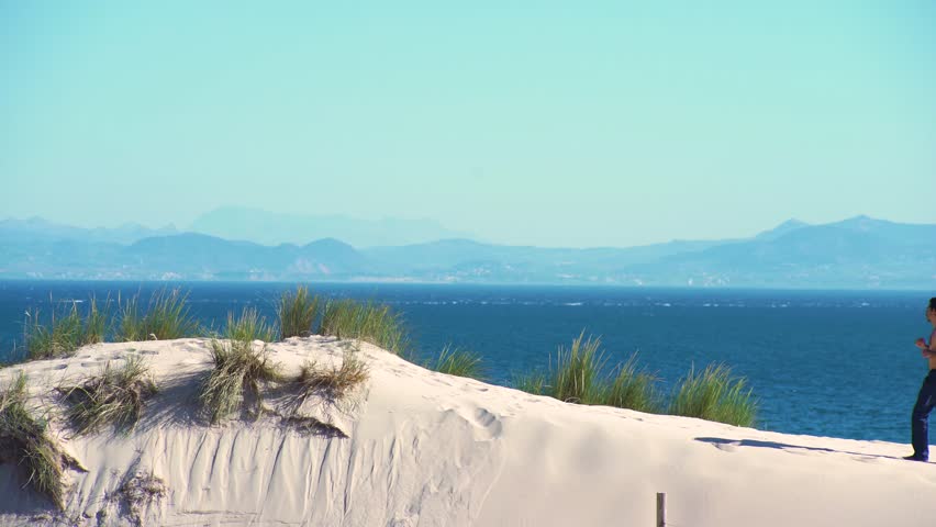 Young man exercising in a dune sand