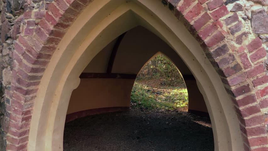 Man with scary Halloween mask and machete near old gates