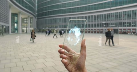A subjective view of a hand holding a futuristic glass phone and creating a network of people around him. Concept of: future, holography, network, team work and technology.