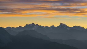 Panoramic video on the Alps at sunset. Colorful sky, high altitude mountain peaks with glaciers, Massif des Ecrins National Park, France.
