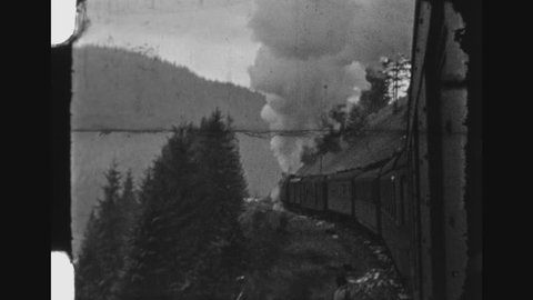 UKRAINE, WINTER 1942. German Military Locomotive Train Traveling Through Mountains. POV Shot Out Of Train Window.
