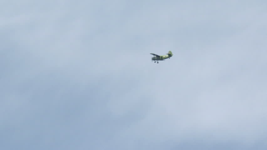 Skydivers jumping from an airplane. White parachute on blue sky background .
