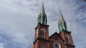 Video of a cathedral with two bell tower steeples taken while the bells were ringing.