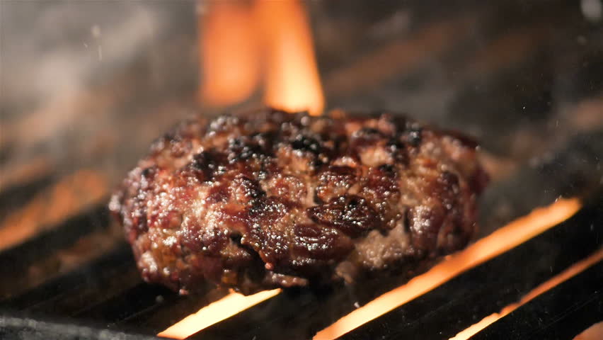 Beef Burger And Spatula On The Hot Flaming BBQ Charcoal Grill, Close-up Royalty-Free Stock Footage #32036575