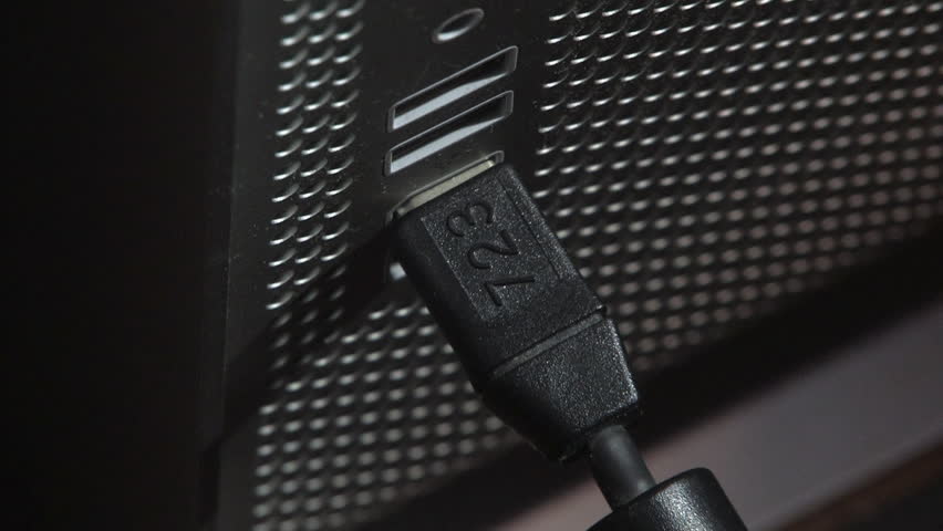 Inserting and removing a USB cable from a computer.