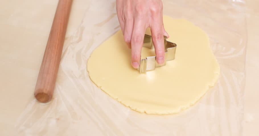 Cutting cookies on dough 