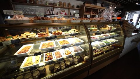 Showcase with pastries and salads in a cafe-bakery, slow motion