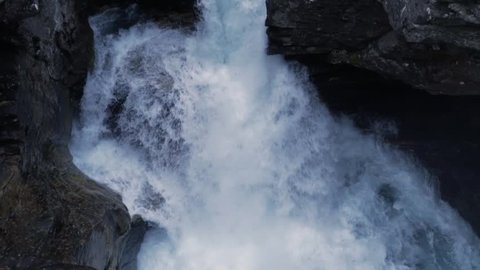 HD Slow Motion Waterfall in Norway with Rocks and Forest, Pan Up