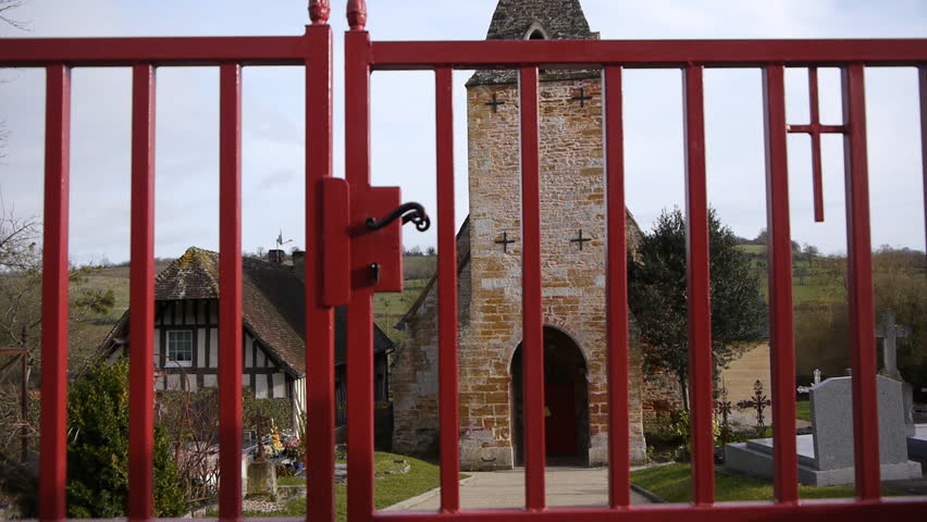 Opening gate in front of a church in Guerquesalles France.