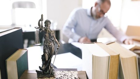 The Statue of Justice - lady justice goddess of Justice in lawyers office - smooth tracking shot
