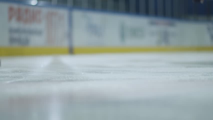 Ice hockey. Close-up of hockey skates. The hockey player does the braking on the ice.