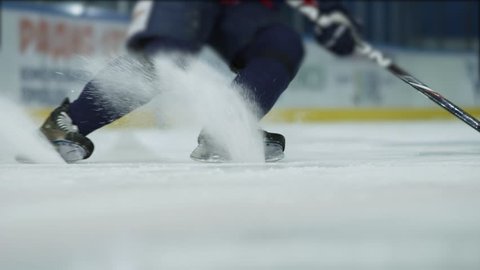 Ice hockey. Close-up of hockey skates. The hockey player does the braking on the ice.