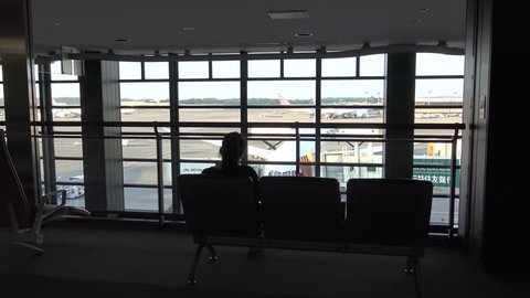 Japan-07 July, 2017: 4K Moving Dolly, Beautiful view of Passenger Boarding Area in Tokio International Airport. People travelling with suitcase for business or tourism in the terminal-Dan