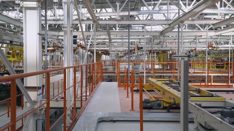 Automobile plant, new car body moves along the conveyor, modern production of cars, automated production line.
