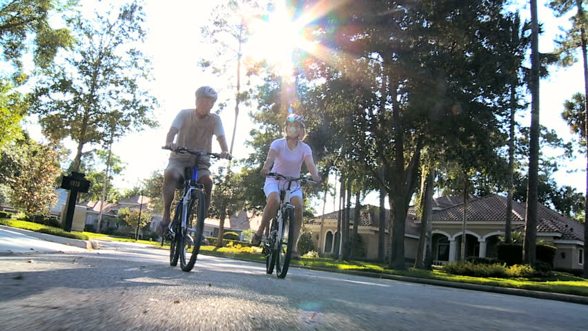 Senior couple keeping fit riding their bicycles outdoors