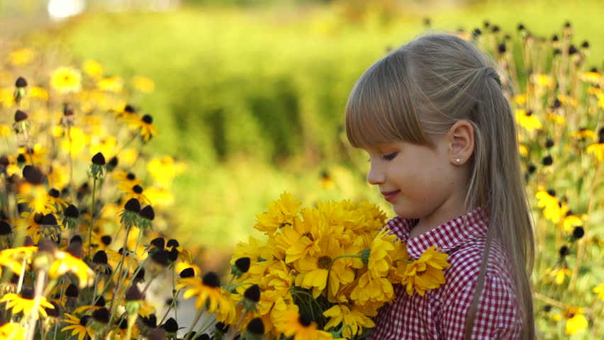 Close-up portrait of a girl with yellow flowers