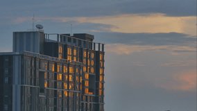 4K Time lapse video of reflection of sunset shade over modern high building.