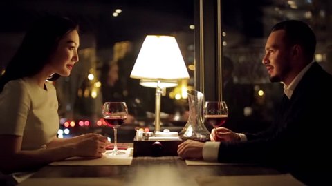 Young Couple Toasting Wine Glass In Luxury bar. Dating.