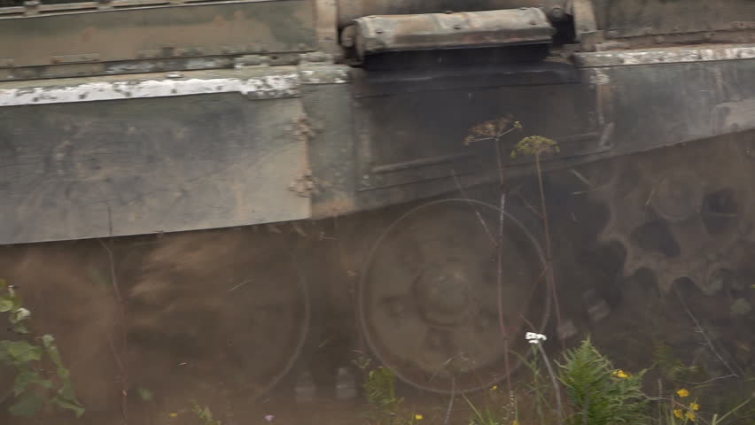 Tank rides on the field. Slow Motion. 