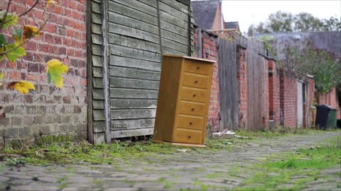 Abandoned furniture left in an old cobbled back alley for collection.