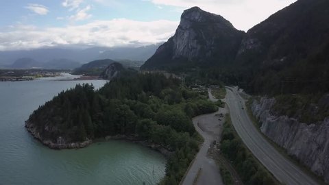 Aerial view of ocean inlet in Howe Sound, near Squamish City, with Chief Mountain in the background. Taken during an early morning, North of Vancouver, British Columbia, Canada.