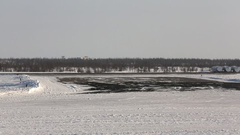 airplane on the runway, the plane is landing, snow-covered runway, small passenger plane,  Russia