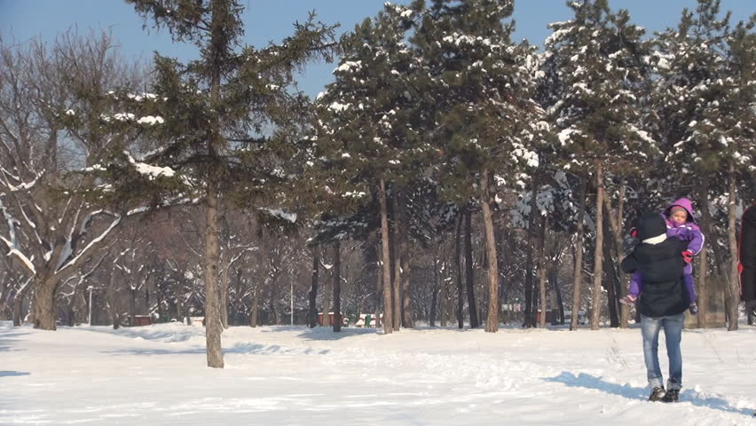 Family Walking through Snow