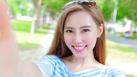 beauty woman selfie happily in the park