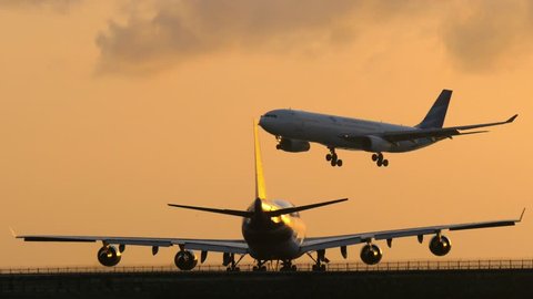 BALI, INDONESIA -  OCTOBER 15, 2017: Passenger air plane landing to airport runway during sunset