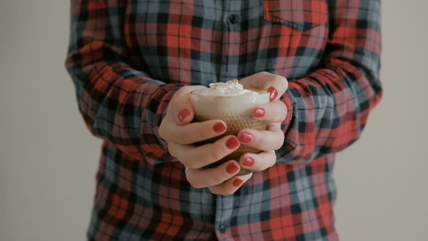 Woman hands holding hot cup of coffee