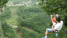 Man and child having fun moving on zip line above big canyon - Powered by Shutterstock - Get 15% off with code: PIKWIZARD15