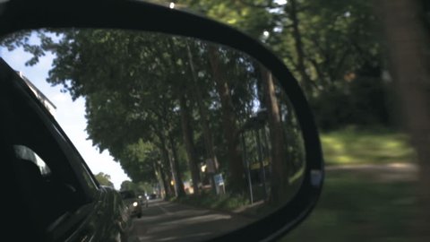 Street Scene Through a Rearview Mirror of a Moving Car